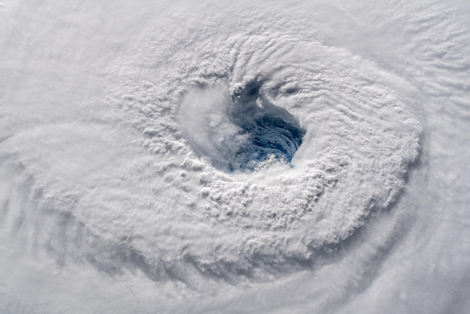 The eye of Hurricane Florence photographed from the International Space Station, a deep well ringed by towering cloud